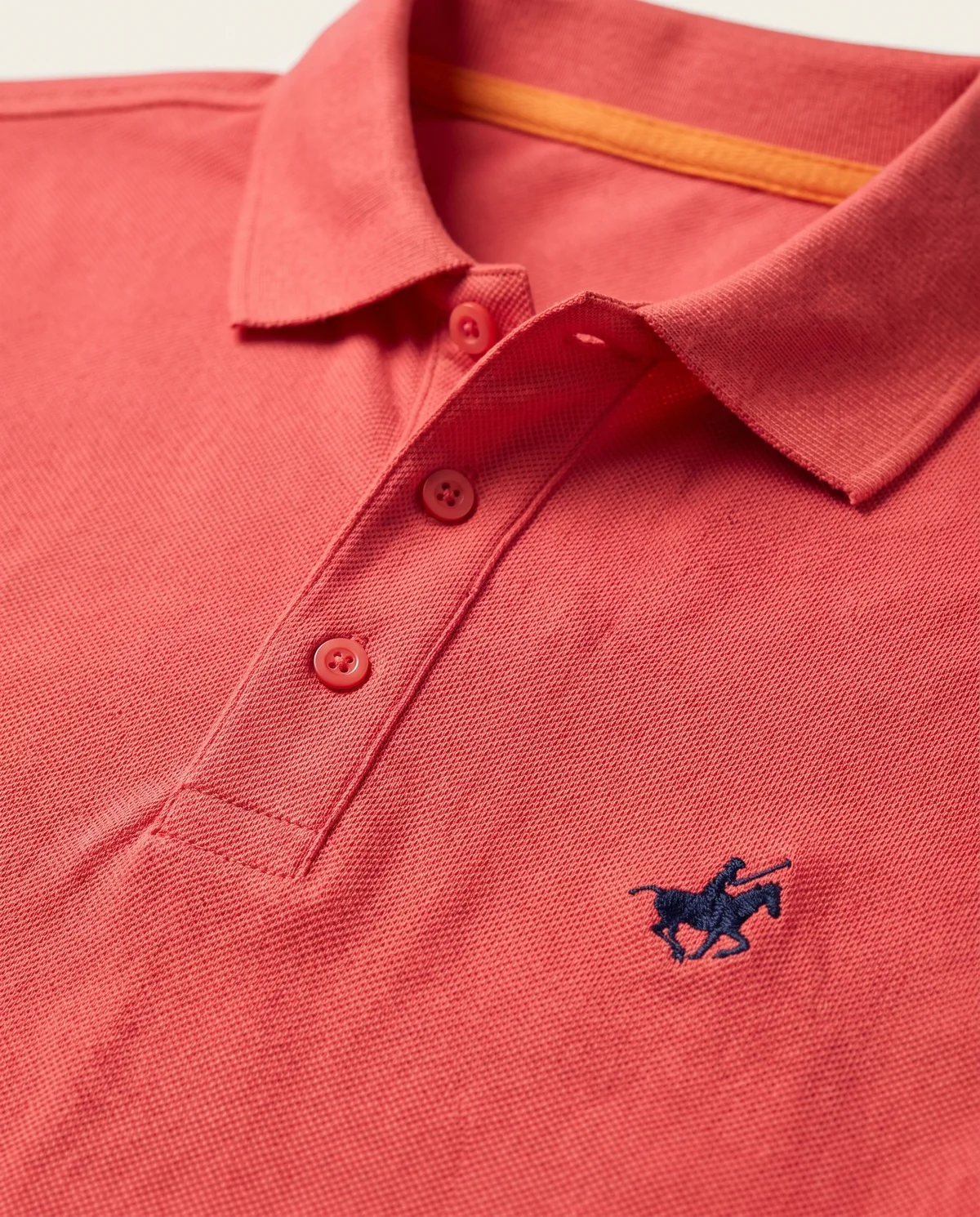 Piqué Polo in Coral, fabric and stitching detail